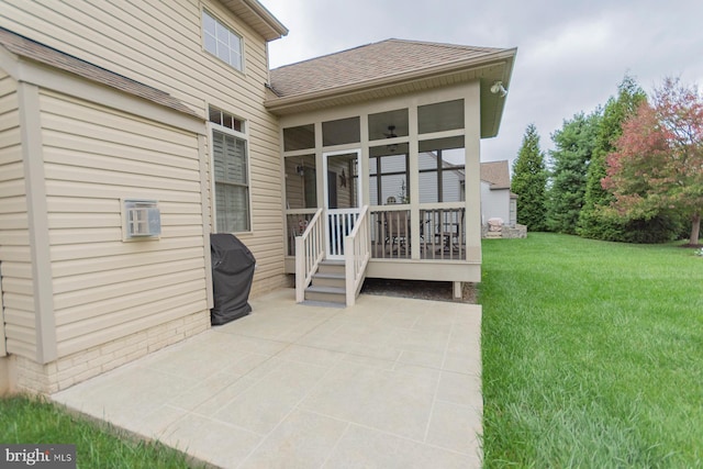 rear view of property with a patio, a yard, and a sunroom