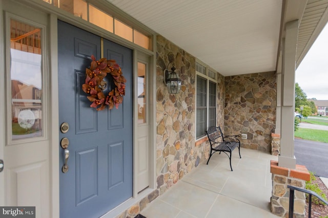 entrance to property featuring a porch