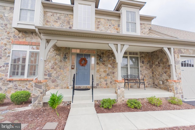 property entrance featuring a porch and a garage