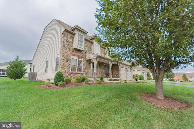 view of front facade with a front yard and central AC