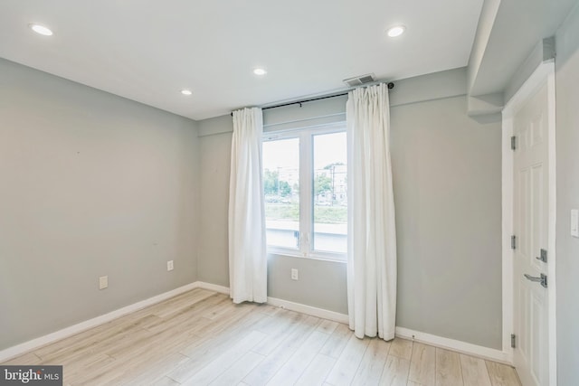 spare room featuring light hardwood / wood-style flooring