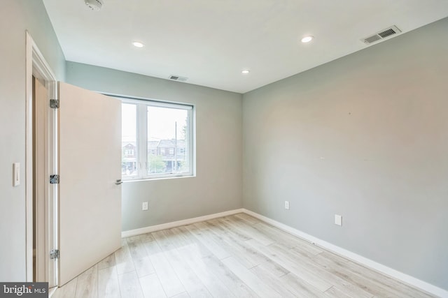 spare room with light hardwood / wood-style flooring