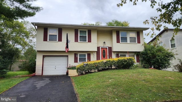 split foyer home with a front yard and a garage