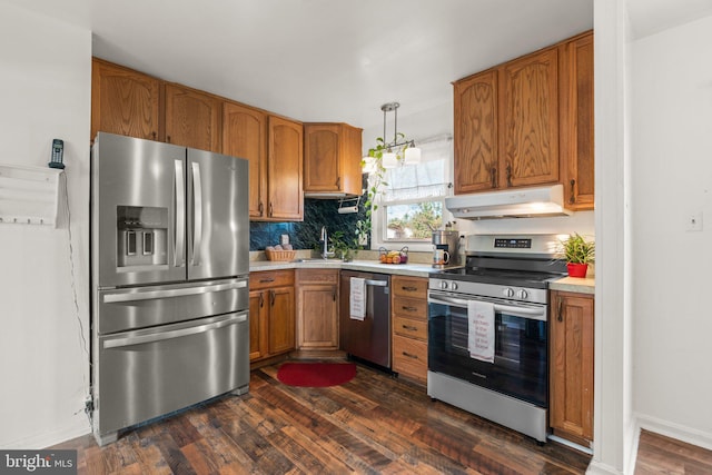 kitchen with dark hardwood / wood-style flooring, stainless steel appliances, tasteful backsplash, and sink