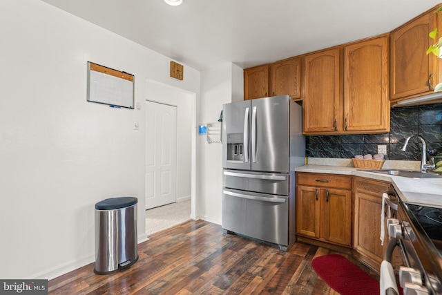 kitchen featuring decorative backsplash, sink, dark wood-type flooring, and stainless steel appliances