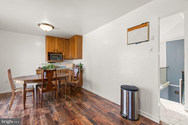 dining area with dark hardwood / wood-style flooring