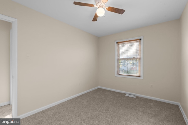 carpeted empty room with ceiling fan