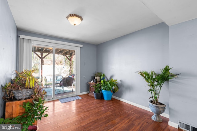 sitting room with wood-type flooring