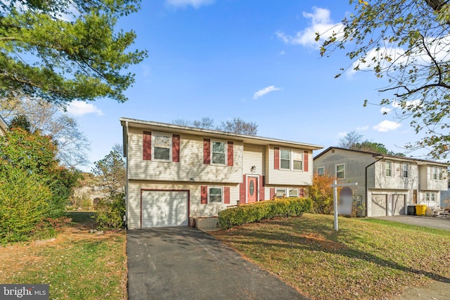 bi-level home with a front lawn and a garage