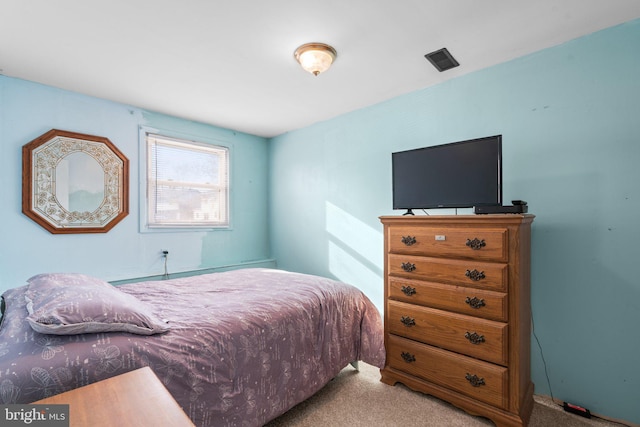 bedroom with light colored carpet