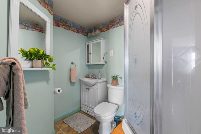 bathroom with tile patterned floors, toilet, vanity, and walk in shower