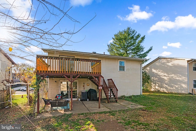 back of property featuring a patio, a deck, and a lawn