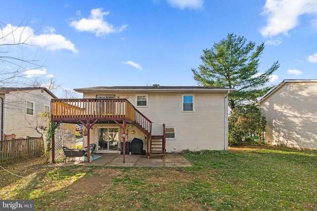 rear view of house with a yard, a patio area, and a wooden deck