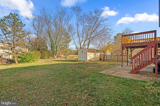 view of yard with a shed and a wooden deck