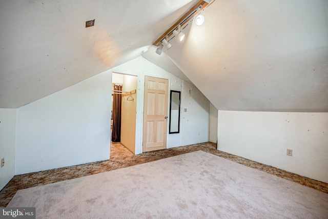 additional living space with vaulted ceiling and light colored carpet