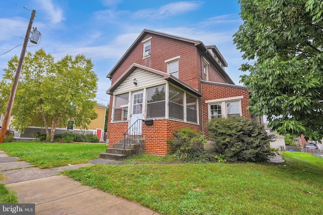 view of front of house with a front lawn and a sunroom