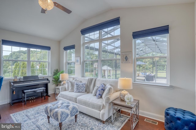 living room featuring lofted ceiling, ceiling fan, and dark wood-type flooring