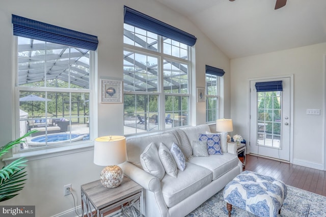 living room with lofted ceiling, hardwood / wood-style floors, ceiling fan, and a wealth of natural light