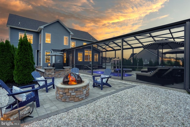 patio terrace at dusk featuring an outdoor fire pit