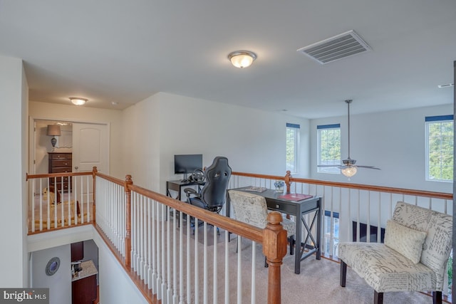 interior space with ceiling fan and a wealth of natural light