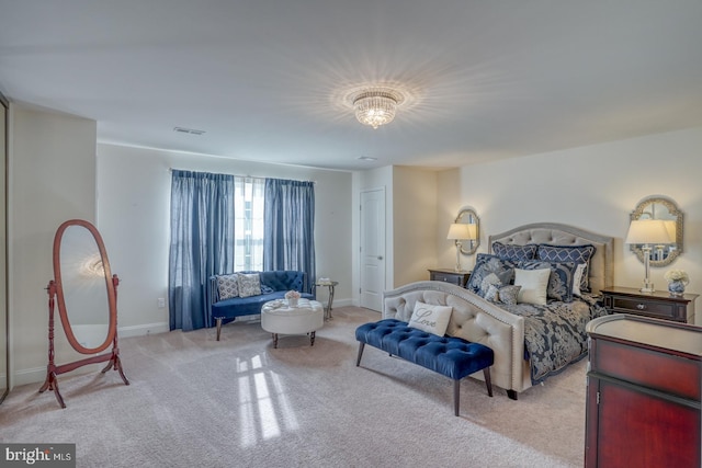 bedroom featuring a chandelier and light colored carpet