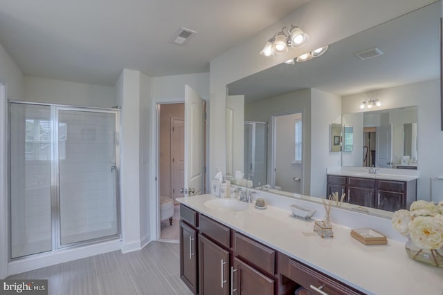 bathroom featuring vanity and a shower with shower door