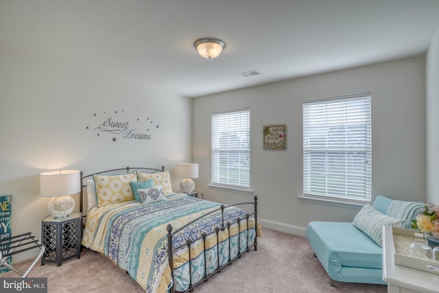 bedroom featuring light carpet