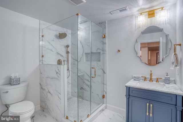 bathroom featuring vanity, toilet, and a shower with shower door