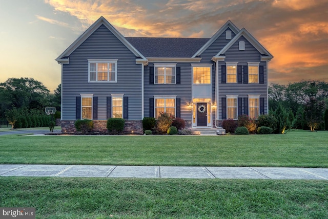 colonial home featuring a yard