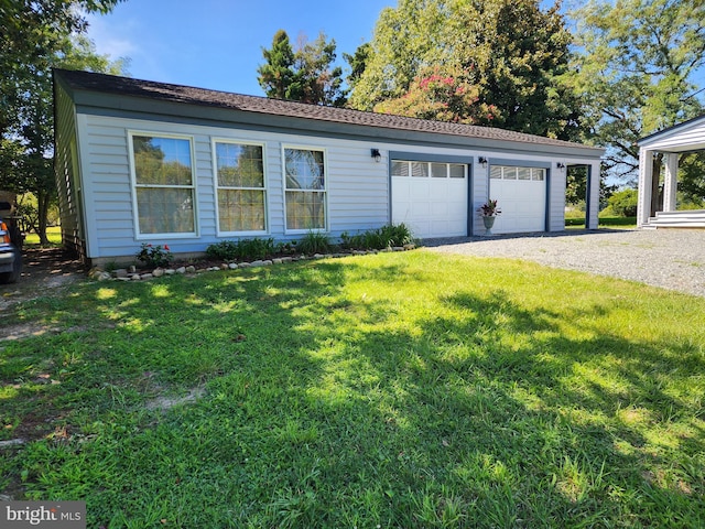 single story home with a front yard and a garage