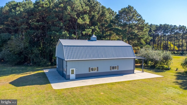 view of home's exterior featuring a patio and a lawn