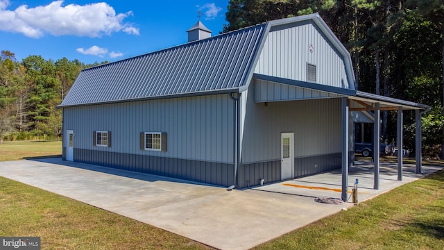 view of side of property with a yard and a carport