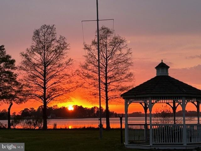 view of home's community with a gazebo, a yard, and a water view