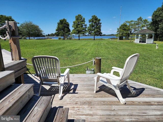 deck featuring a gazebo, a yard, and a water view