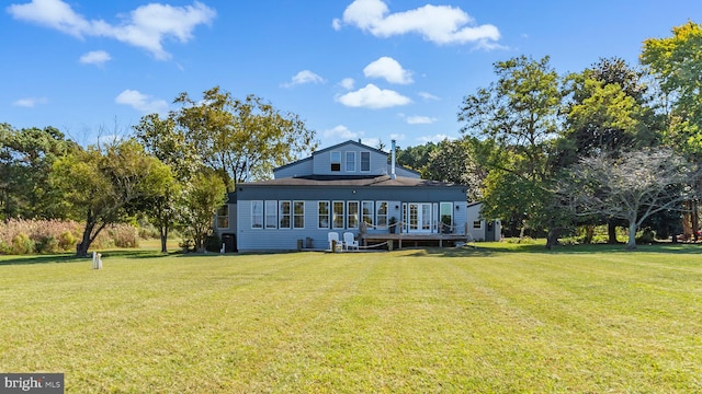 rear view of property with a yard