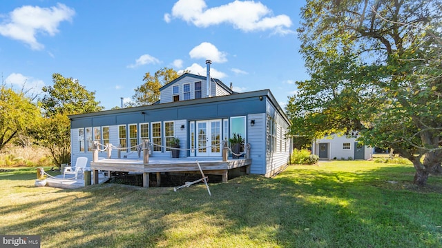 back of house with a wooden deck and a yard