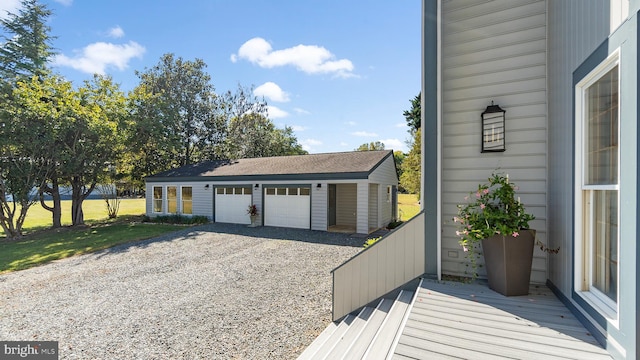 garage with wooden walls and a lawn