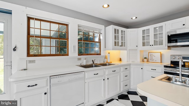 kitchen with sink, white cabinetry, and stainless steel appliances