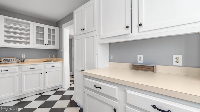 kitchen with white cabinetry and sink