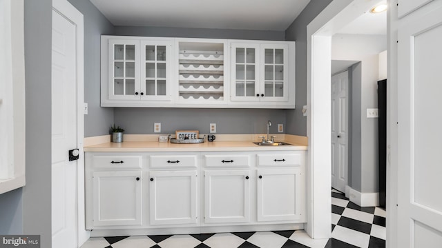 bar with sink and white cabinets