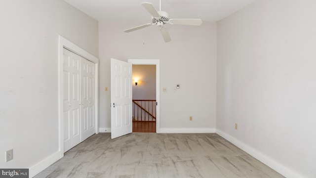 unfurnished bedroom with light carpet and ceiling fan