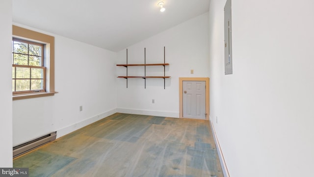 unfurnished room featuring electric panel, wood-type flooring, a baseboard radiator, and vaulted ceiling