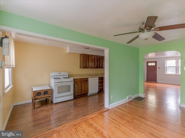 kitchen featuring ceiling fan, light hardwood / wood-style floors, and white appliances