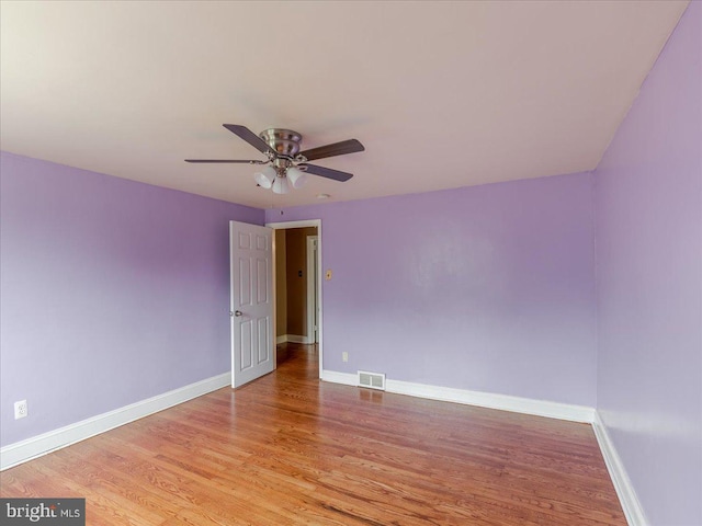 spare room featuring light hardwood / wood-style floors and ceiling fan