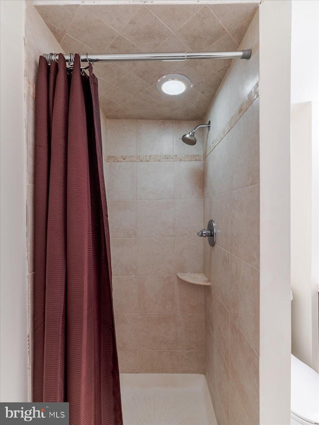 bathroom with a shower with shower curtain