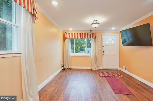 doorway to outside featuring ornamental molding and hardwood / wood-style flooring