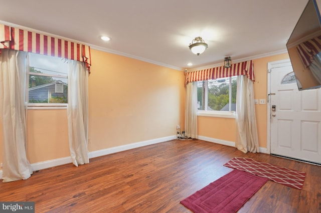 foyer with hardwood / wood-style flooring and crown molding