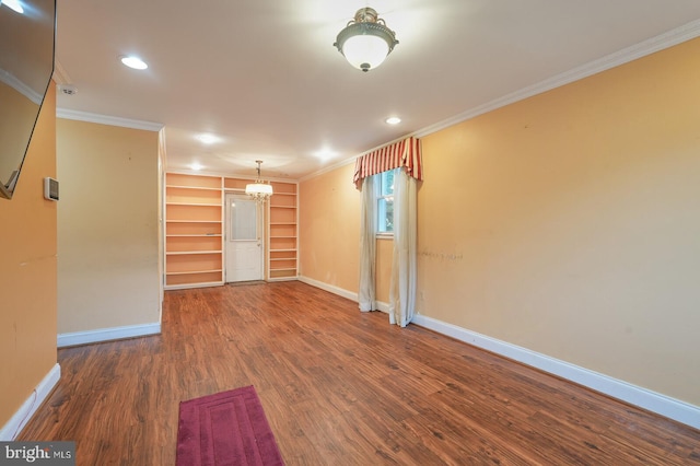 empty room featuring ornamental molding and wood-type flooring