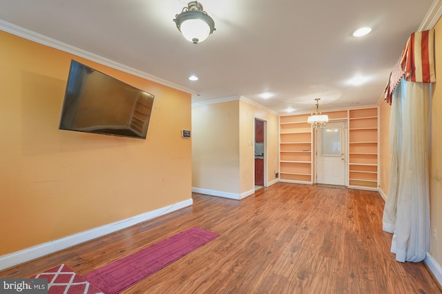 unfurnished room with crown molding and hardwood / wood-style floors