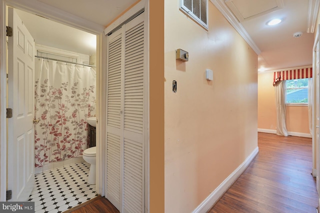 hall with crown molding and hardwood / wood-style floors